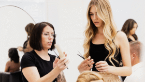 Hairdressing training session with student learning professional haircut techniques